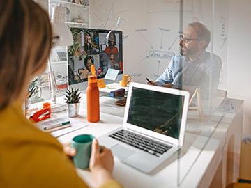 Two colleagues in an office on a video call