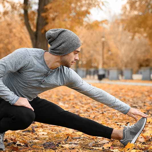 Man running fast on path through woods