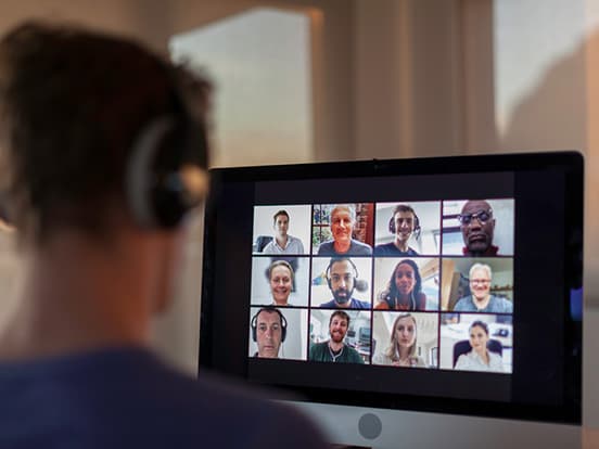 Person sat at computer on a video call with colleagues