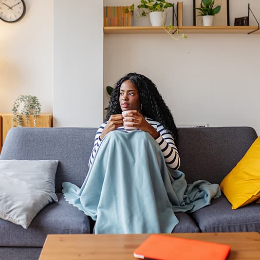 Cody lady on sofa holding mug