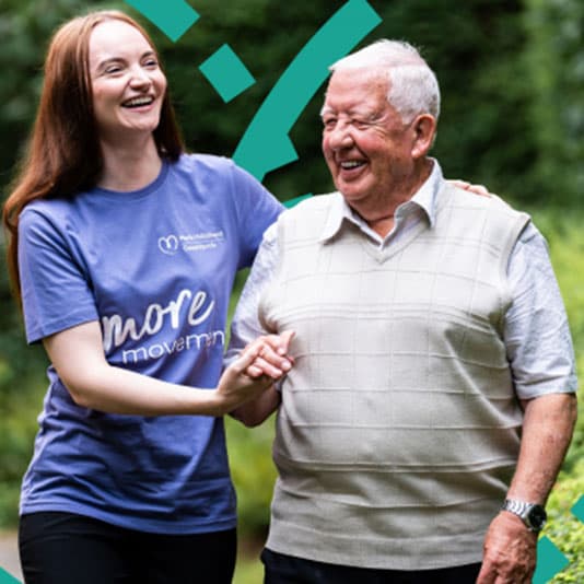 Maria Mallaband carer walking with an elderly man