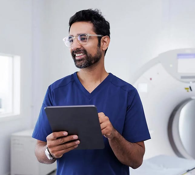 Health professional standing next to imagining machine