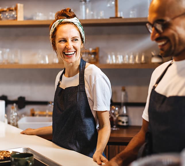 Two colleagues smiling together at work